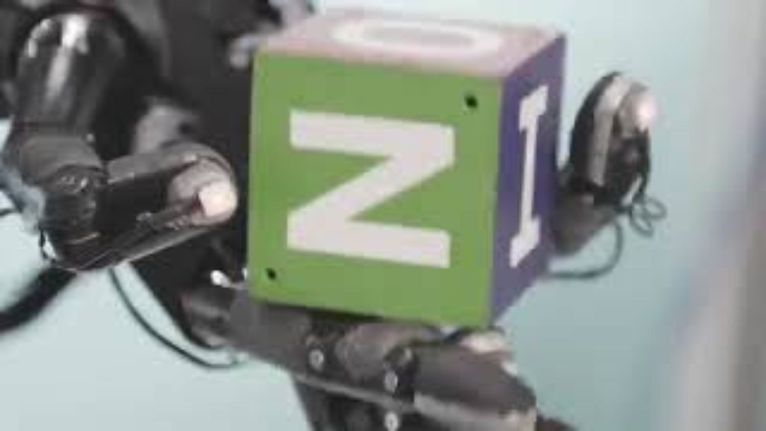 Robotic hand rolling a cube with its fingers