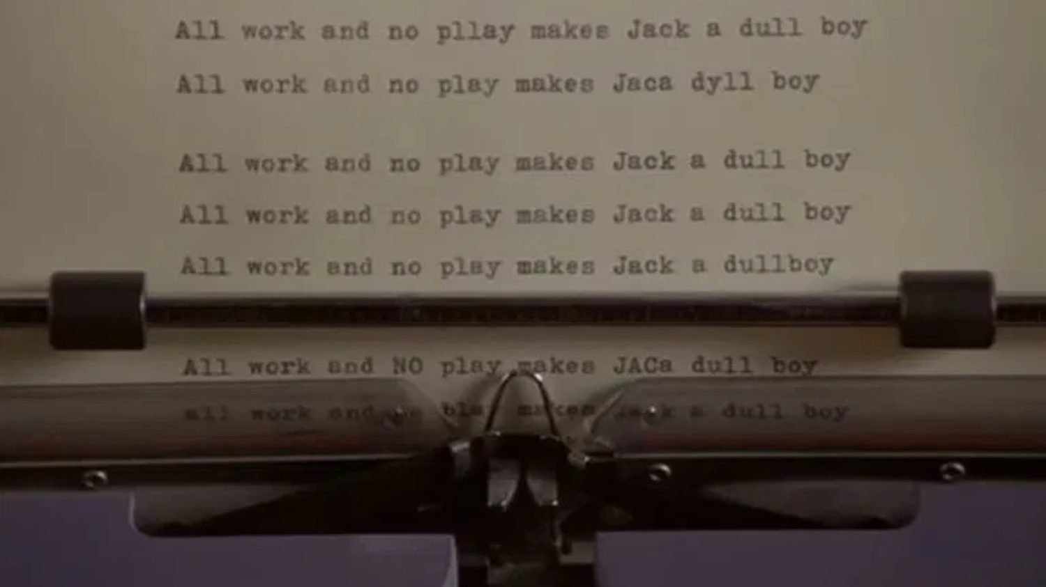 Typewriter spitting out paper with "All work and no play makes Jack a dull boy" from The Shining
