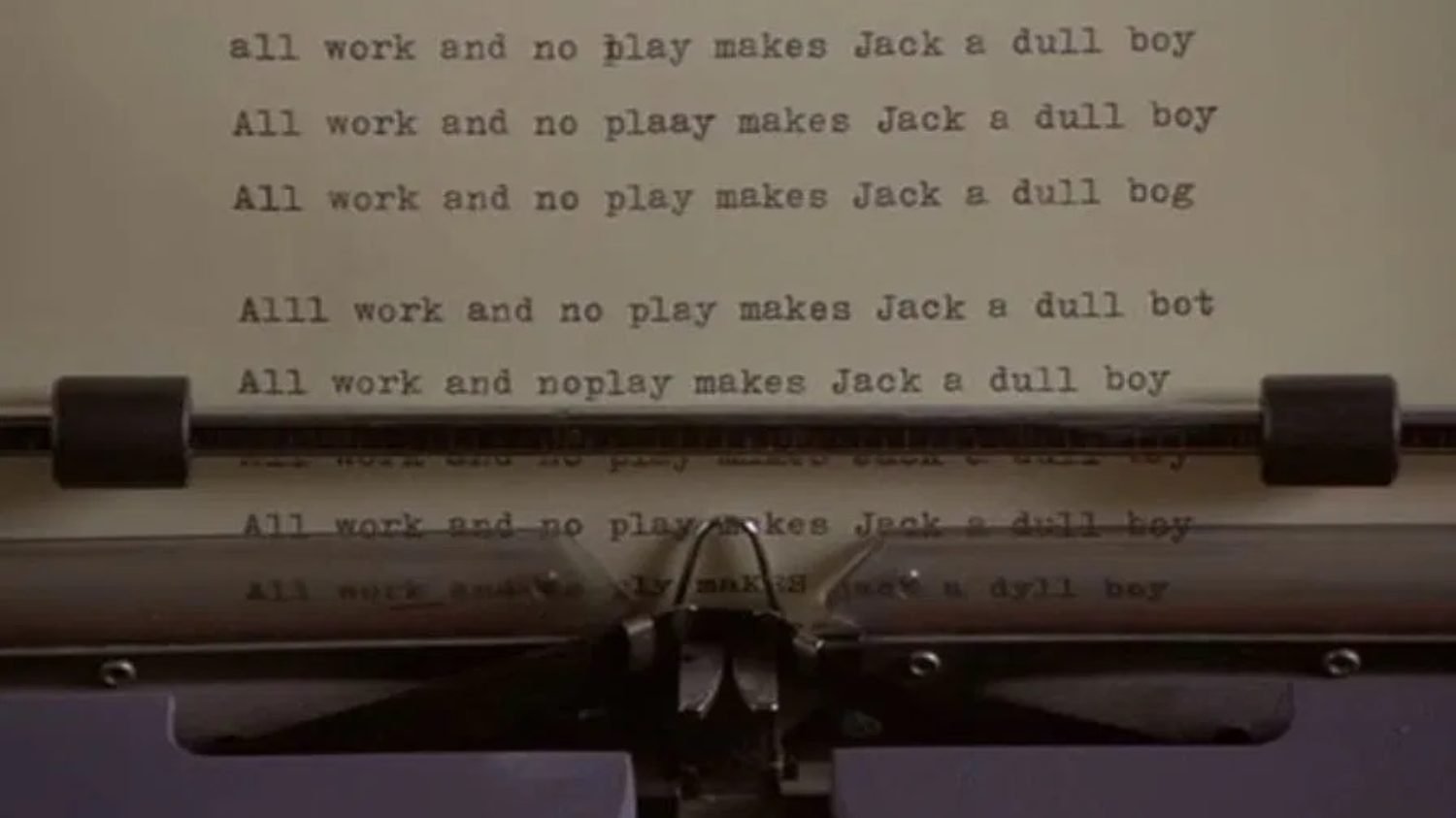 Typewriter spitting out paper with "All work and no play makes Jack a dull boy" from The Shining